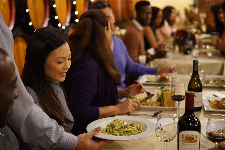 Close up of woman being served pasta at winery event