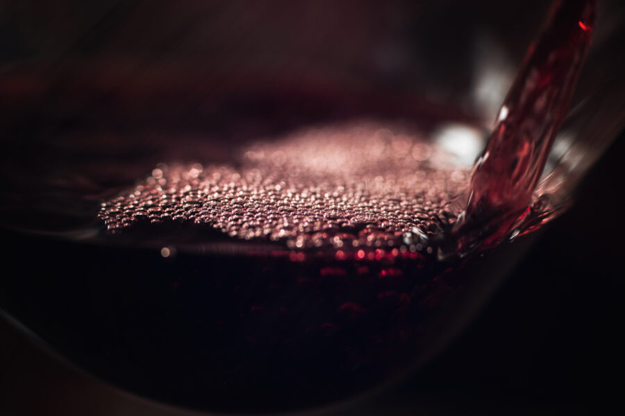 pouring-deep-red-wine-in-glass